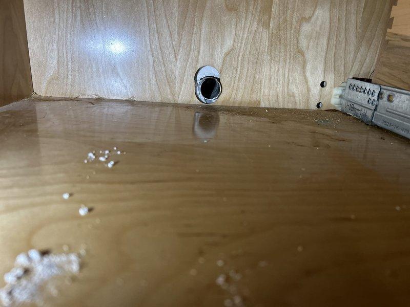 Diagnosed and repaired dual plumbing issues including a leaking shower valve assembly in the bathroom and water seepage from kitchen sink plumbing. Discovered water damage to the wooden cabinet structure beneath the kitchen sink and evidence of ongoing leakage at the shower control valve connection, requiring replacement of valve cartridge and seals along with repair of affected cabinet materials.