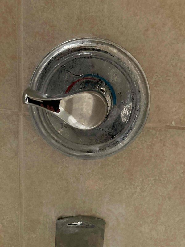 Responded to repair job for a shower valve leak. Identified water damage on wooden flooring with moisture accumulating from a wall pipe penetration. Replaced faulty shower valve components, including wiring connections, and restored proper function to the fixture.