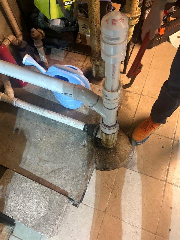 Responded to priority service call for washing machine drain backup issue in basement. Upon inspection, discovered significant buildup in the main PVC drainage pipe connecting to the washing machine discharge line. Successfully cleared the obstruction using drain cleaning equipment and verified proper drainage function with multiple test cycles.