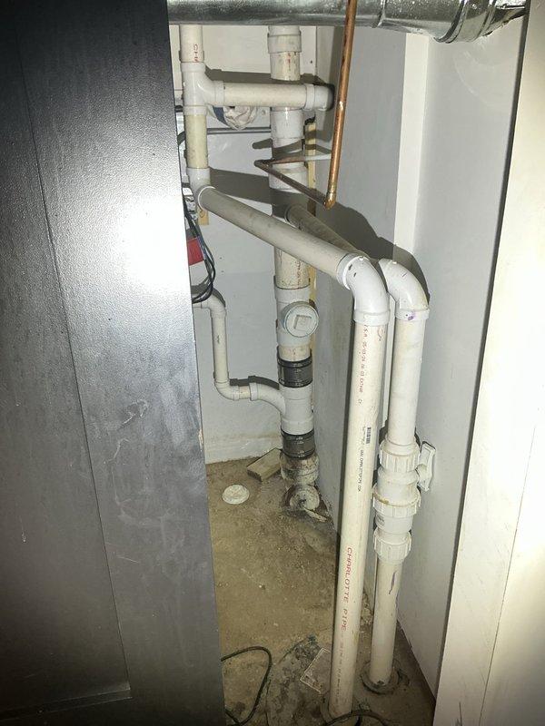 Conducted an on-site assessment of residential drain and sewer system, including visual inspection of interior plumbing installation in utility area with multiple PVC pipes, connections, and a copper pipe component. Performed camera inspection of sewer line, documenting interior pipe condition at 52'1" depth, revealing textured surface with potential debris/buildup that may require remediation.