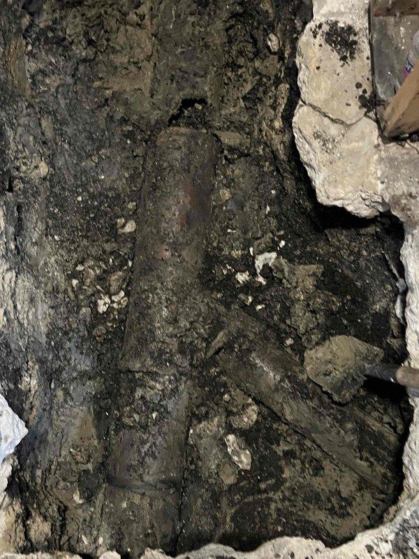 Excavated access point to install new main sewer line. Encountered saturated soil conditions requiring careful trenching around existing underground utilities. Successfully installed and positioned the new main line pipe with proper grade for optimal drainage.