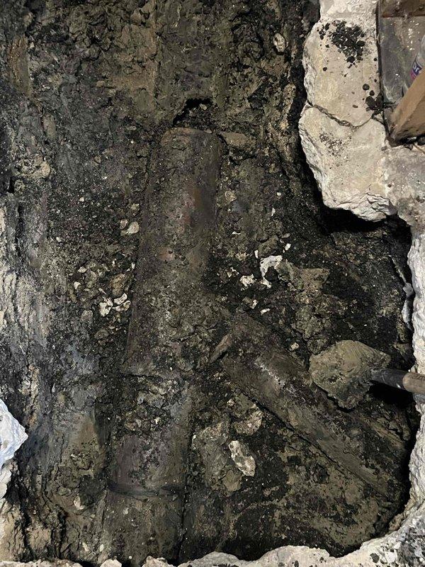 Excavated access point to install new main sewer line. Encountered saturated soil conditions requiring careful trenching around existing underground utilities. Successfully installed and positioned the new main line pipe with proper grade for optimal drainage.