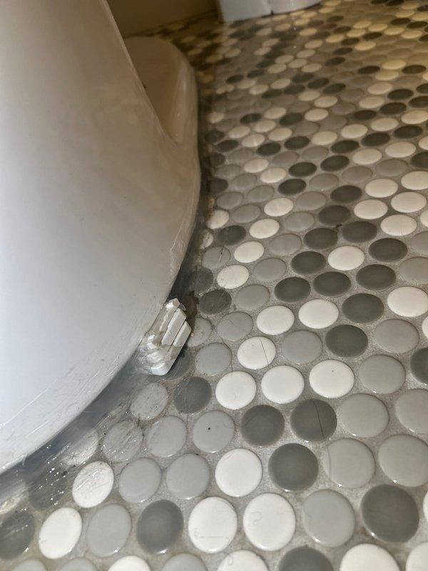 Performed toilet pull and reset service. Identified issue with the shim during reinstallation. Additional caulking required at the base of toilet where moisture was observed between porcelain fixture and penny tile flooring to ensure proper seal and prevent water seepage.