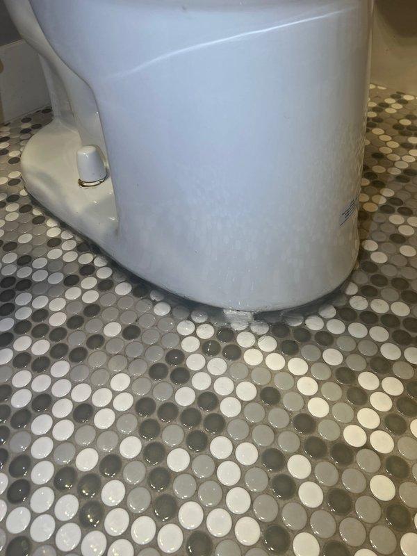 Performed toilet pull and reset service. Identified issue with the shim during reinstallation. Additional caulking required at the base of toilet where moisture was observed between porcelain fixture and penny tile flooring to ensure proper seal and prevent water seepage.