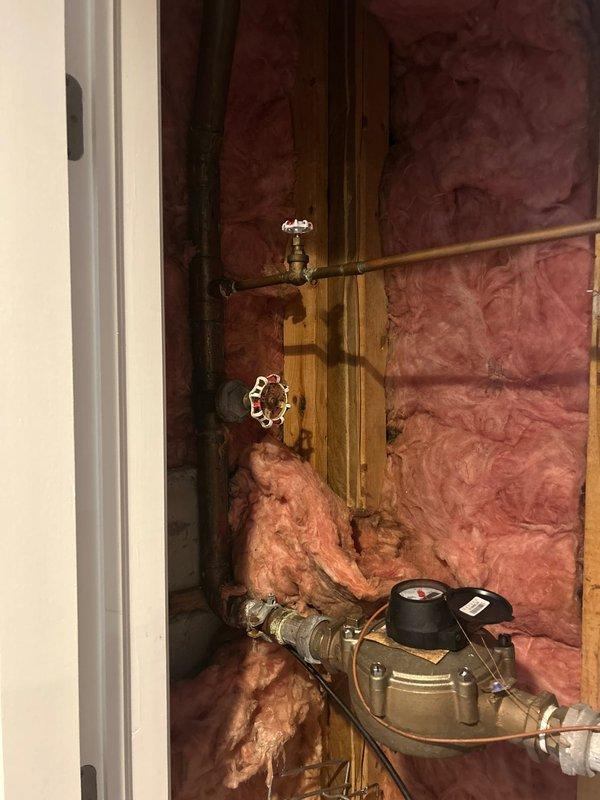 Repaired faulty gate valves located in insulated wall cavity. Replaced worn components on both the red/white control wheel valve and brass finish valve, restoring proper functionality and eliminating spinning issue. System now operates correctly with no leaks observed at connections.