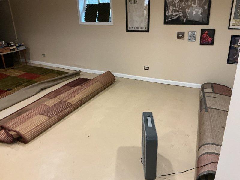 Responded to service call regarding water intrusion from floor during recent rainfall. Inspection revealed water was entering through foundation near exterior access point, not from interior plumbing. Cleared debris from exterior drain access point and removed deteriorated wooden materials that were obstructing proper drainage flow around foundation.