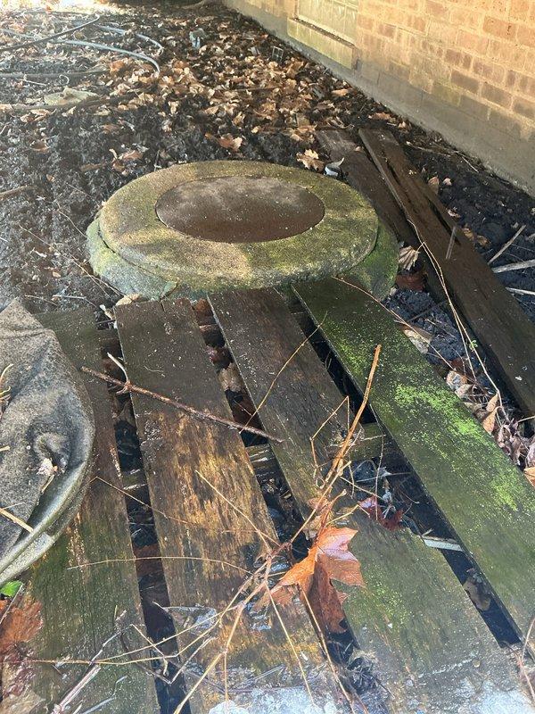 Responded to service call regarding water intrusion from floor during recent rainfall. Inspection revealed water was entering through foundation near exterior access point, not from interior plumbing. Cleared debris from exterior drain access point and removed deteriorated wooden materials that were obstructing proper drainage flow around foundation.