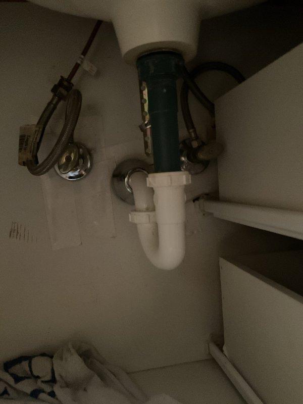 Responded to service call for a leaking pipe under sink in 20-year-old home, where issue had been ongoing for approximately one week. Upon inspection, identified deteriorated P-trap connection as source of leak. Replaced damaged section of PVC drainage assembly, installed new P-trap with proper seals, and verified all connections were secure. Tested repair by running water through system for 3 minutes with no leaks observed.