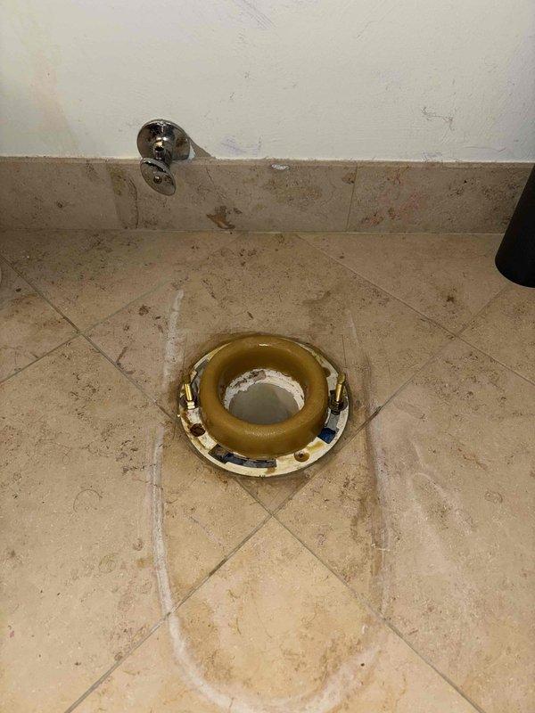 Performed sewer scope with camera inspection as part of VIP service agreement. Inspected water heater connections including hot water line and Franke-branded components. Examined toilet floor flange installation with existing wax ring, noting some corrosion on the flange and water staining on surrounding floor tiles.
