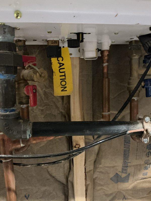 Completed priority camera inspection of plumbing system as rescheduled. Documented key infrastructure components including copper supply lines with caution-tagged valves and a PVC drain line with red control valve. Inspection revealed system appears functional with normal wear, with special attention paid to tagged connection points.