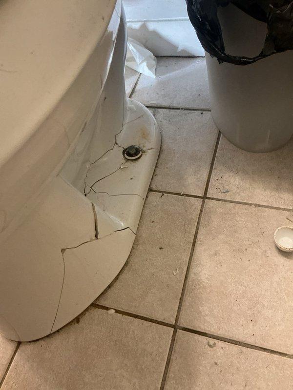 Removed damaged toilet with severely cracked porcelain base and replaced flange which showed significant water damage with staining on surrounding tile. Completed installation of new toilet with proper mounting hardware and verified secure connection to plumbing system with no leaks.