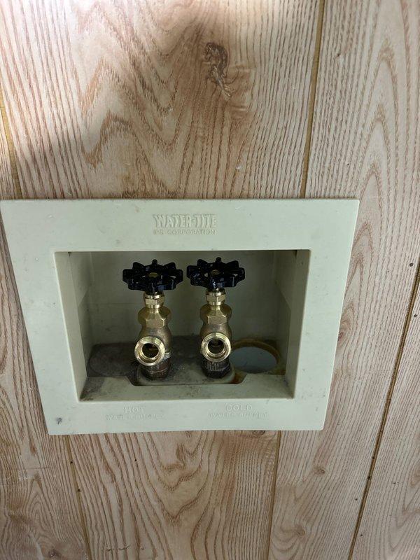 Inspected plumbing system with focus on brass fittings and water valve installation, documenting the condition of components including a water access point labeled "WATERRITE" with hot and cold connections. Noted tarnishing on brass components and verified proper function of valves after service completion.