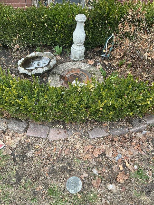 Responded to service call for sewage backup in basement floor drains. Inspection revealed water damage on concrete basement floor with visible staining and debris. Located and examined exterior sewer cleanout access point in garden area; determined gate valve was malfunctioning, causing backup issues. Rodded main sewer line to restore proper drainage function.