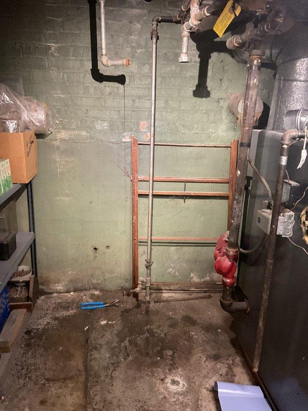 Responded to no hot water complaint from customer with 20-year-old 50-gallon water heater that ceased functioning two days prior. Upon inspection of the utility basement, observed the aging water heater adjacent to the furnace unit with visible signs of deterioration. Recommended replacement of the obsolete unit due to age and complete failure.