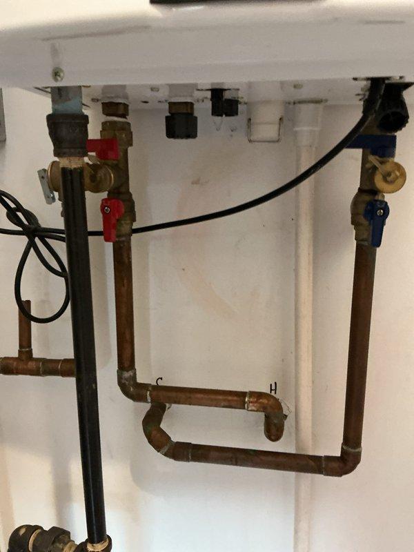 Completed routine maintenance flush on tankless water heater system to remove mineral buildup and ensure optimal performance. Inspected all copper piping connections, verified proper function of isolation valves (both hot and cold sides), and checked for any signs of leakage or corrosion. System was successfully returned to service with proper flow rates restored.