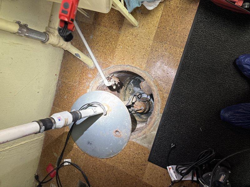Accessed floor drain system to address deteriorated plumbing infrastructure. Inspection revealed significant corrosion and mineral buildup on pipe joints and fittings within the concrete drainage structure. Service included snaking the drain line to clear blockage and assessment of components for future replacement as scheduled.
