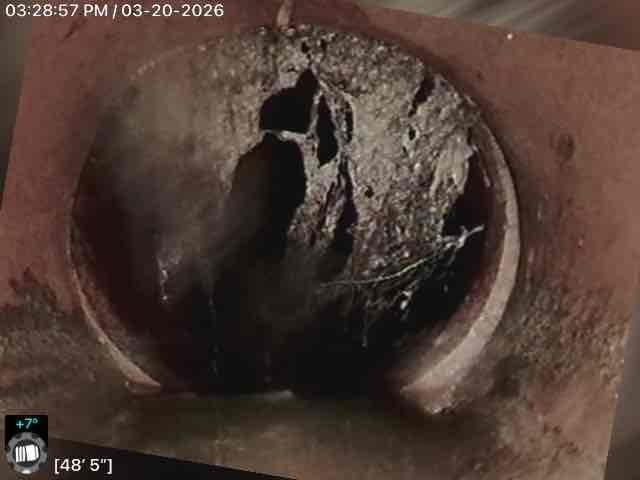 Conducted inspection of residential sewer line using camera system, identifying significant pipe deterioration at approximately 34'6" and 48'5" depths. Observed substantial mineral deposits, structural damage including visible cracks, and potential blockage in what appears to be clay/terracotta piping, recommending drain tile and sump pump installation to address these issues.