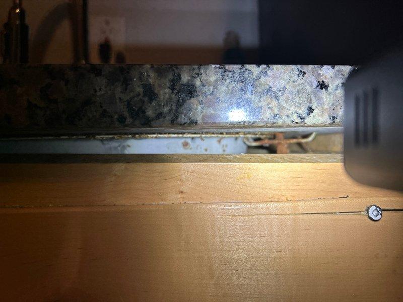 Conducted leak detection service in response to customer's high water bill concerns. Performed comprehensive inspection of bathroom fixtures and under-sink cabinet area. No active leaks identified at toilet or countertop/cabinet junction; recommended continued monitoring of water meter and usage patterns.