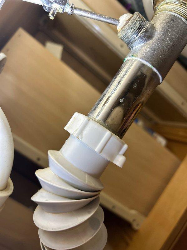 Replaced deteriorated flexible accordion drain pipe and worn p-trap assembly under bathroom sink which was causing significant leakage. Installed new chrome p-trap with proper fittings and ensured all connections were secure and leak-free.