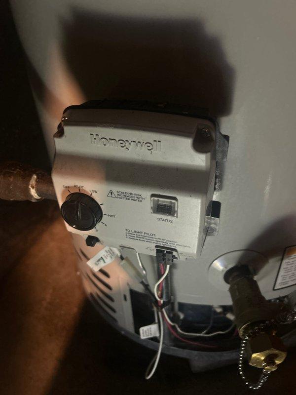 # Water Heater Inspection and Replacement Estimate

Conducted comprehensive inspection of residential gas water heater to assess operational condition and determine replacement necessity. Examined Honeywell gas control valve and thermostat assembly, evaluating temperature regulation functionality and pilot light operation. Inspected burner assembly at base of unit, noting accumulated debris and sediment buildup in combustion chamber. Assessed copper supply piping connections showing age-related discoloration and patina formation. Documented condition of gas control components, electrical connections, and manufacturer specifications via detailed photography. Based on inspection findings including compromised burner performance, potential control valve deterioration, and overall unit age, provided professional recommendation for complete water heater replacement to ensure safe and efficient operation.