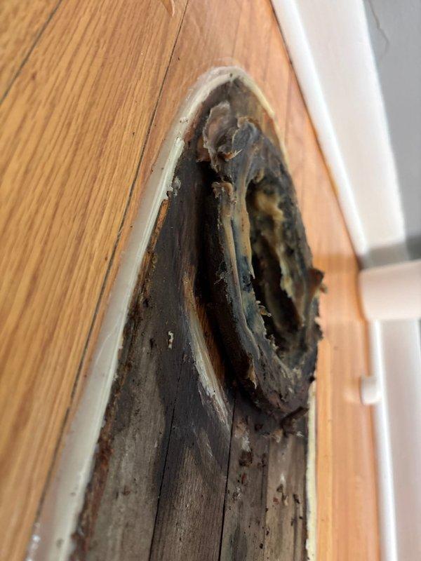 Responded to emergency call for active water leak in basement near furnace area. Upon arrival, conducted thorough inspection of plumbing systems, drainage lines, and surrounding mechanical components in the vicinity of the hot water heater where customer reported large dripping. 

Investigated copper supply lines, drainage piping, and ductwork throughout the basement ceiling space to locate the source of the leak. Examined exposed joists, OSB sheathing, and all visible plumbing connections for signs of water damage, moisture accumulation, or active dripping. Traced potential leak paths from upper floor drainage systems down through the basement infrastructure.

During inspection, identified significant fire damage to an electrical outlet fixture on wooden door frame, which required documentation but was outside the scope of the plumbing leak investigation. Photographed all relevant areas including mechanical systems, ductwork, and structural components for documentation purposes. Compl