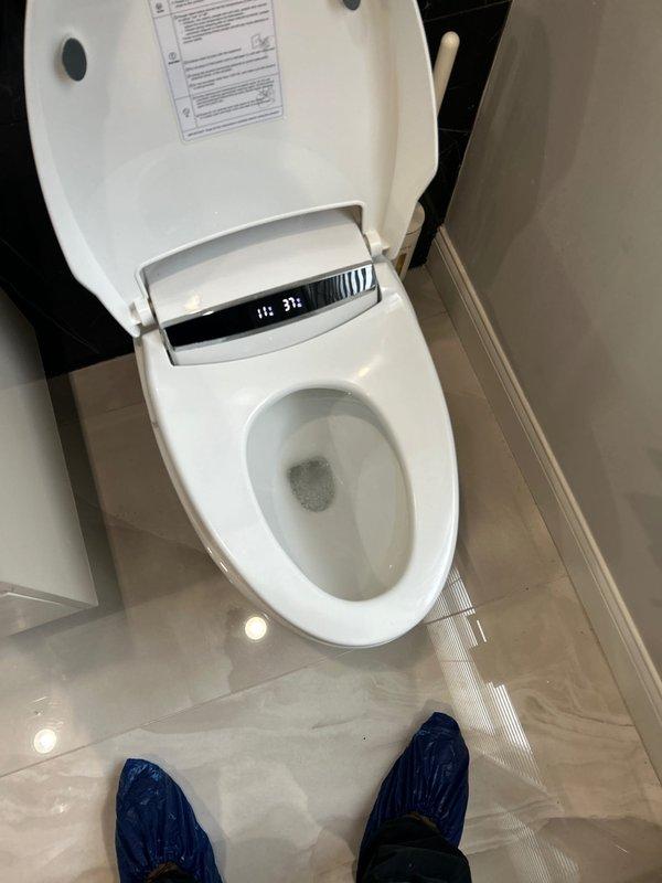 Responded to service call for non-flushing smart toilet with integrated bidet system. Upon arrival, found toilet bowl containing standing water with debris, indicating flush mechanism failure. Inspected electronic bidet unit with digital control panel and determined malfunction in smart toilet's flushing system. Diagnosed issue, cleared blockage, and restored proper flushing function to the electronic toilet fixture, verifying all bidet controls and flush operations returned to normal working condition.