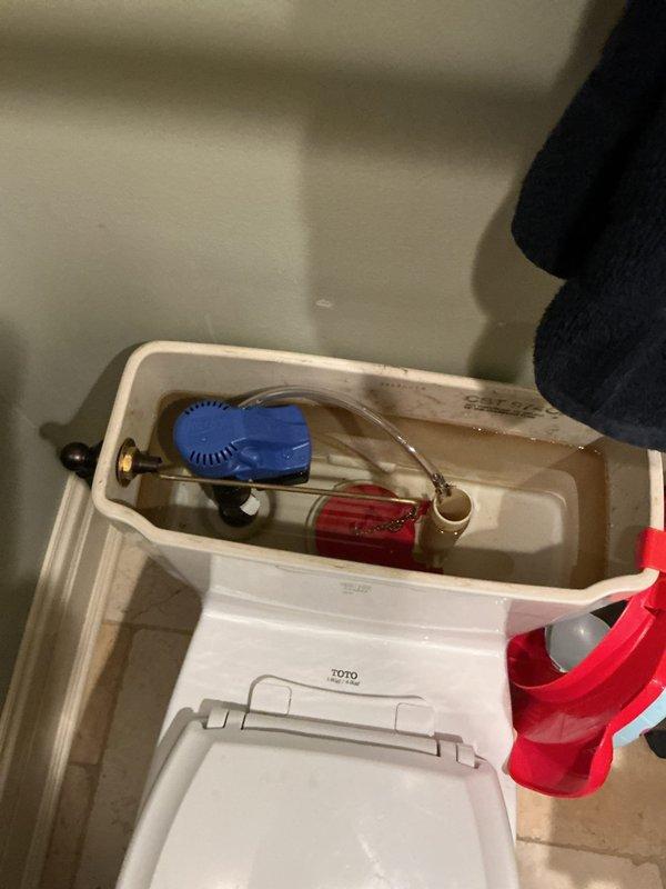 Responded to customer report of toilet running continuously for two weeks in a 17-year-old residential property. Upon arrival, removed tank lid and inspected internal flushing mechanism. Found discolored water in tank with low fill level, indicating potential fill valve malfunction. Examined float assembly, overflow tube, flush valve, and flapper components for wear and proper operation. Identified issues with the fill valve assembly causing continuous water flow. Adjusted float mechanism and tested flush cycle to ensure proper tank refill and shutoff. Verified all internal components were functioning correctly and water flow ceased after repairs. Tank refilled to appropriate level with clear shutoff operation confirmed.