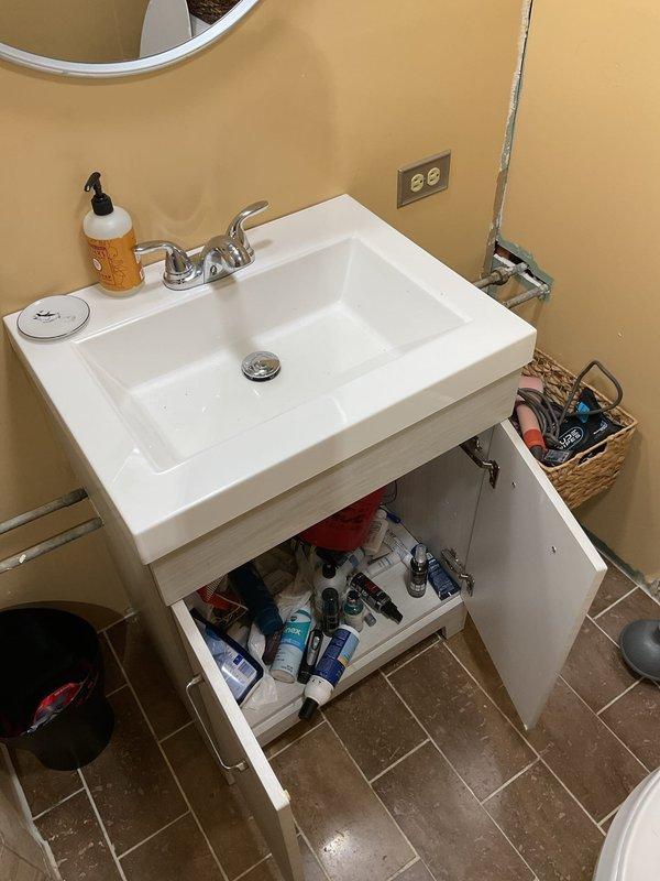 Responded to emergency drain backup affecting multiple fixtures across three floors. Upon inspection, found water and black debris backing up through basement bathroom sink and shower, with backflow occurring in upper floor sink when plunger was applied, indicating main drain line obstruction. Successfully cleared blockage in primary drain line, restoring proper drainage flow throughout all affected fixtures. Verified system operation and confirmed no further backflow issues.