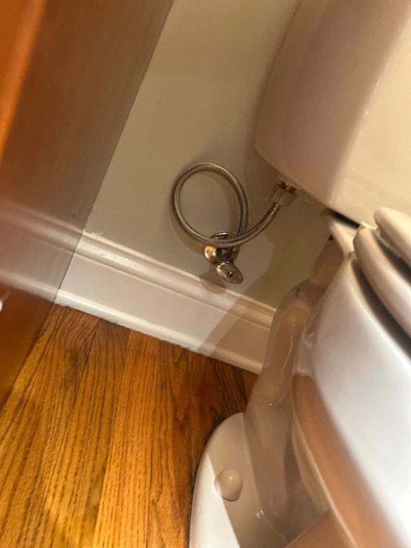 Responded to repair request for slow leak from toilet water supply line and slow tank refill issue. Upon inspection, identified compromised braided metal supply hose with brass fittings showing signs of deterioration at connection points. Removed tank lid to assess internal flush mechanism and diagnosed worn flapper valve and fill valve assembly requiring attention. Replaced defective water supply line with new flexible braided stainless steel connector, ensuring proper seal at wall shutoff valve and toilet tank inlet. Serviced fill valve assembly to restore proper flow rate and adjusted float mechanism to correct water level. Installed new flapper valve and chain assembly to ensure complete seal and prevent water waste. Tested system through multiple flush cycles to verify proper refill speed and confirm elimination of supply line leak. All components functioning to manufacturer specifications upon completion.