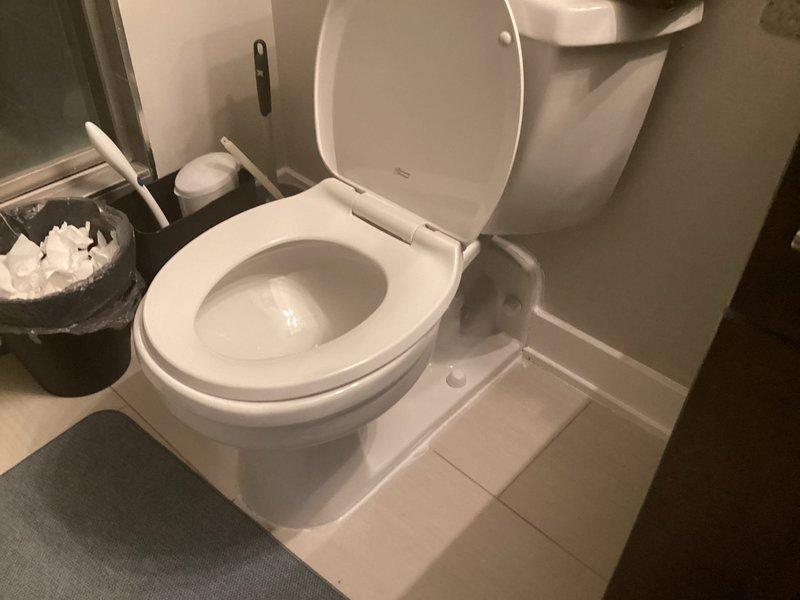 Completed plumbing service call for toilet inspection and maintenance. Upon arrival, assessed toilet fixture and surrounding bathroom components for proper operation and potential issues. Documented existing conditions of standard two-piece toilet with tank-mounted flush lever, verifying water levels in bowl and confirming proper seating on tile flooring. Inspected all visible plumbing connections and verified no signs of leaks or water damage around base or supply lines. Fixture found to be in satisfactory working condition with all components functioning as designed.