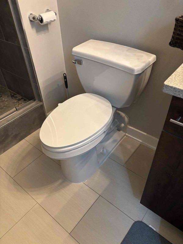 Completed plumbing service call for toilet inspection and maintenance. Upon arrival, assessed toilet fixture and surrounding bathroom components for proper operation and potential issues. Documented existing conditions of standard two-piece toilet with tank-mounted flush lever, verifying water levels in bowl and confirming proper seating on tile flooring. Inspected all visible plumbing connections and verified no signs of leaks or water damage around base or supply lines. Fixture found to be in satisfactory working condition with all components functioning as designed.