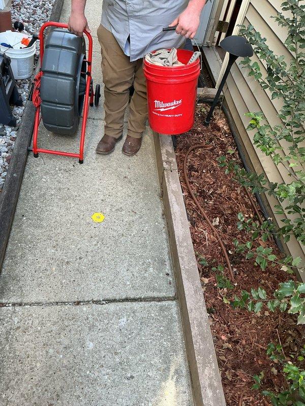 Conducted on-site residential drain and sewer system estimate at single-family property. Performed exterior inspection of accessible plumbing access points along side yard walkway, documented existing conditions with photographic evidence, and assessed property layout for potential service line work. Equipment staged for comprehensive evaluation of drainage system.