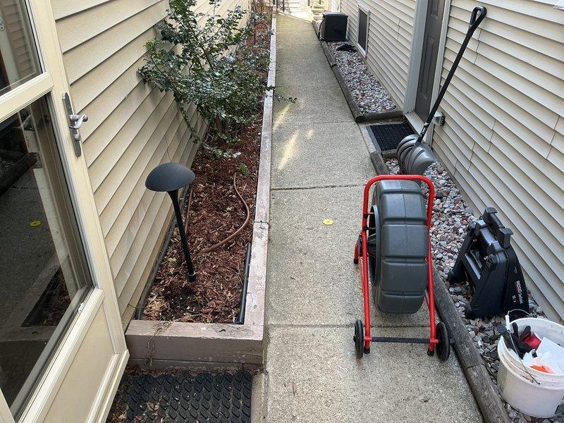 Conducted on-site residential drain and sewer system estimate at single-family property. Performed exterior inspection of accessible plumbing access points along side yard walkway, documented existing conditions with photographic evidence, and assessed property layout for potential service line work. Equipment staged for comprehensive evaluation of drainage system.