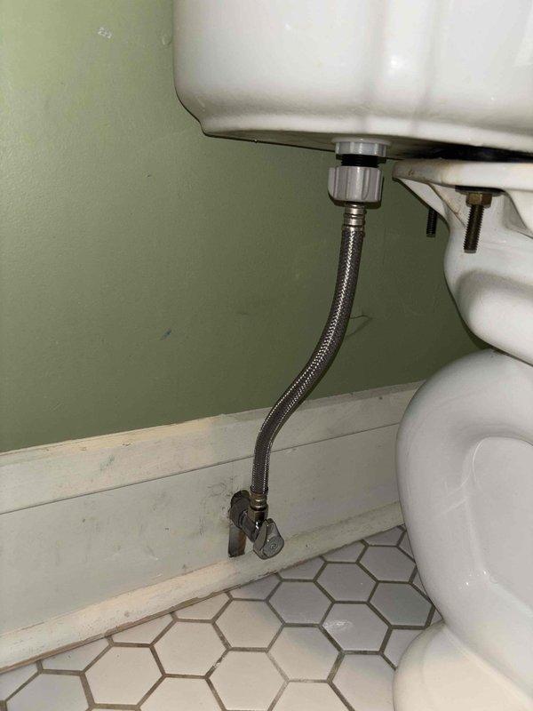 Responded to service call for multiple plumbing issues including a bathroom sink draining slowly due to clog that had worsened over the past week. Inspected and addressed the clogged bathroom sink drainage issue. Additionally, evaluated a leaking shut-off valve behind toilet that required replacement, as evidenced by corroded brass fitting with visible water damage and mineral deposits on adjacent water heater tank. Documented existing plumbing conditions including deteriorated valve connections and potential need for master bathroom shower drain rodding service.