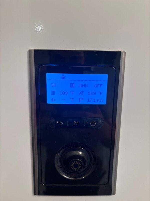 Responded to callback for recurring error code on Navien tankless water heater system. Upon arrival, unit was operating normally with display showing 109°F and no active fault codes present. Inspected installation including wall-mounted unit, PVC venting system, copper supply and return lines, and integrated filtration components. Verified all connections, fittings, and control panel functionality. System appeared to have self-resolved since previous service visit. Documented current operating conditions with photos for warranty records.