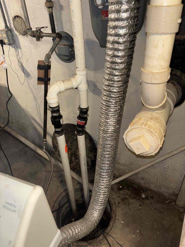 # Sump Pump Replacement Estimate

Responded to service call for malfunctioning sump pump that continuously runs without shutting off. Upon inspection, identified sump pump in basement utility area with failing float switch mechanism causing continuous operation. Assessed existing sump pit configuration with multiple PVC discharge lines and determined complete pump replacement necessary. Documented existing installation including corroded piping connections, aged flexible ductwork in vicinity, and deteriorated concrete floor conditions around pit opening. Provided comprehensive estimate for new sump pump installation with proper float switch assembly and discharge piping upgrades to restore proper automatic operation and prevent potential basement flooding.