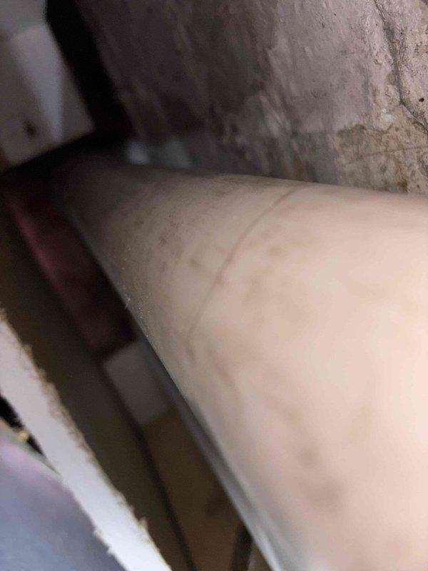 Inspected plumbing infrastructure in crawlspace area and documented existing conditions of exposed piping system and surrounding concrete foundation walls. Photographed large-diameter supply or drain line showing normal wear patterns and concrete surfaces displaying age-related discoloration for customer records and future reference. Job sold and documented for repair authorization.