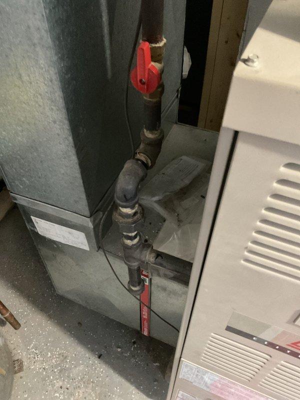 Responded to emergency gas leak on supply line serving furnace. Upon arrival, found active gas leak at corroded pipe coupling with gas supply still energized, creating immediate safety hazard. Shut off gas at main valve, verified leak location at deteriorated black iron pipe joint near water heater, and performed pressure test to confirm system integrity after repairs. Replaced failed coupling section, applied appropriate pipe dope and thread sealant, and restored gas service. Conducted final leak detection test using approved methods to ensure all connections were secure before returning system to operation.