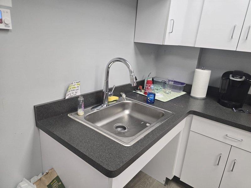 Returned to complete previously sold plumbing repair work in kitchenette and utility sink areas. Successfully installed new chrome pull-down faucet at kitchen sink and wall-mount faucet with dual handles at utility basin, ensuring proper water flow and secure mounting. All installations tested and verified operational.