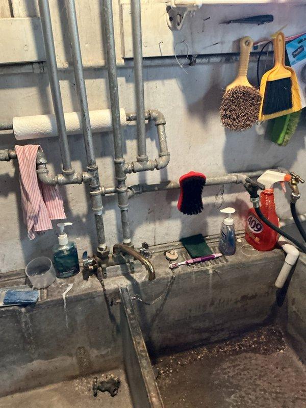 Responded to ongoing faucet issues in a residence over 50 years old, addressing multiple leaking and non-functional fixtures. Inspected extensive plumbing system including utility room piping network and under-counter copper supply lines. Documented existing conditions of aging infrastructure, noting corroded copper pipes with oxidation and deteriorated connections throughout the water supply system requiring repair or replacement to restore proper function.