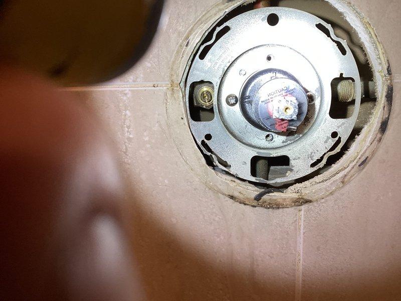 Performed water heater control valve inspection and documentation during scheduled building shutdown. Accessed and photographed existing control mechanism showing signs of aging, mineral deposits, and surface wear around mounting area. Inspected internal valve assembly components including brass mounting hardware and central valve stem for proper operation and structural integrity under warranty coverage.