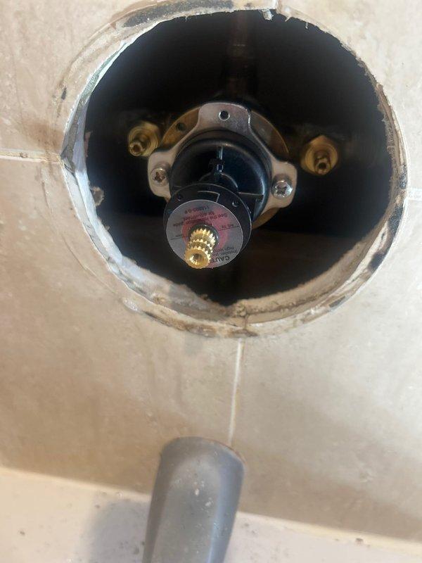 Performed water heater control valve inspection and documentation during scheduled building shutdown. Accessed and photographed existing control mechanism showing signs of aging, mineral deposits, and surface wear around mounting area. Inspected internal valve assembly components including brass mounting hardware and central valve stem for proper operation and structural integrity under warranty coverage.