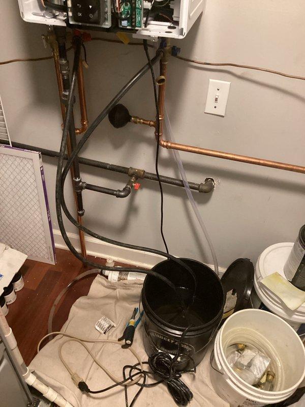 Performed VIP maintenance service on wall-mounted tankless water heater system. Conducted comprehensive inspection of unit's internal electronic components, circuit boards, and control systems with panel access. Flushed and descaled the heat exchanger using appropriate cleaning solutions to remove mineral buildup and maintain optimal heating efficiency. Inspected all copper supply and return piping, connections, valves, and fittings for proper operation and potential leaks. Cleaned inlet filter screen to ensure adequate water flow and prevent debris from entering the unit. Verified all isolation valves, including emergency shutoff valve, were functioning correctly. Tested system operation and confirmed unit was heating water to proper temperature specifications upon completion of maintenance procedures.
