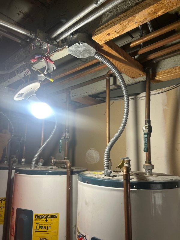 Completed comprehensive plumbing estimate for multi-unit washer installation project involving two separate residential units. Scope includes installation of two laundry boxes with dedicated hot and cold water supply lines routed from existing water heaters in basement, ensuring each unit maintains independent hot water connections. Work requires running new 2-inch drain lines from each unit directly to main sewer line, bypassing existing grease trap configuration currently serving basement washer. Installation includes individual shut-off valves for each washer connection, proper drain line sloping per code requirements, and appropriate venting solutions using either AAV or traditional vent stack connections. Project necessitates accessing and modifying drywall and ceiling surfaces to route supply and drain lines vertically through basement, first floor, and second floor. Site inspection revealed three water heaters in basement with existing copper supply piping infrastructure and exp