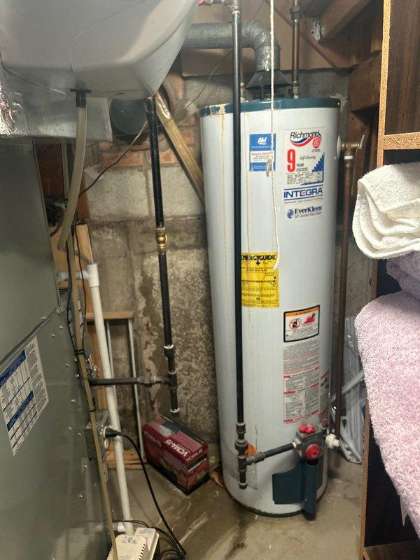 Completed reassembly of shower cartridge as first phase of multi-part service call. Assessed existing Richmond Integra 40-gallon atmospheric water heater in basement utility area, which has exceeded 20 years of service life, and documented equipment condition with photos for estimate preparation. Coordinated follow-up visit for water heater replacement estimate.
