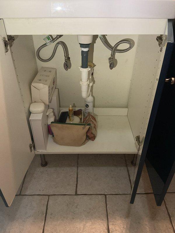 Responded to multiple plumbing leak concerns throughout a multi-unit property. Investigated outdoor spigot leak and identified source requiring repair. Inspected first-floor ceiling leak originating from bathroom above and assessed toilet wax ring condition. Evaluated second-floor ceiling leak traced to third-floor bathroom plumbing. Performed thorough inspection of under-sink plumbing configurations, examining P-trap assemblies, drain connections, and supply line installations to identify potential leak sources. Documented cabinet plumbing conditions including PVC drain assemblies, flexible braided supply lines, and connection points for comprehensive assessment and repair planning.