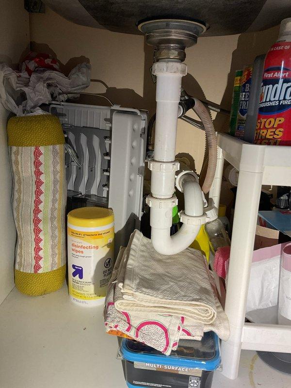 Responded to multiple plumbing leak concerns throughout a multi-unit property. Investigated outdoor spigot leak and identified source requiring repair. Inspected first-floor ceiling leak originating from bathroom above and assessed toilet wax ring condition. Evaluated second-floor ceiling leak traced to third-floor bathroom plumbing. Performed thorough inspection of under-sink plumbing configurations, examining P-trap assemblies, drain connections, and supply line installations to identify potential leak sources. Documented cabinet plumbing conditions including PVC drain assemblies, flexible braided supply lines, and connection points for comprehensive assessment and repair planning.