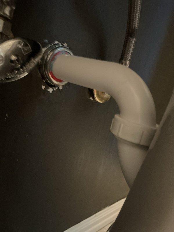 Replaced corroded trap pipe assembly beneath guest bathroom sink in 130-year-old home where fixture is wall-mounted without cabinet enclosure. Removed deteriorated trap that had been causing ongoing drainage issues for approximately four months. Installed new PVC P-trap configuration with proper elbow fittings, ensuring secure connections to wall-mounted tailpiece using metal threaded connectors, locknut assembly, and rubber washers. Connected trap assembly to existing shut-off valves via braided supply lines, verified all connections for proper seal and alignment, and tested system for leaks and proper drainage flow.