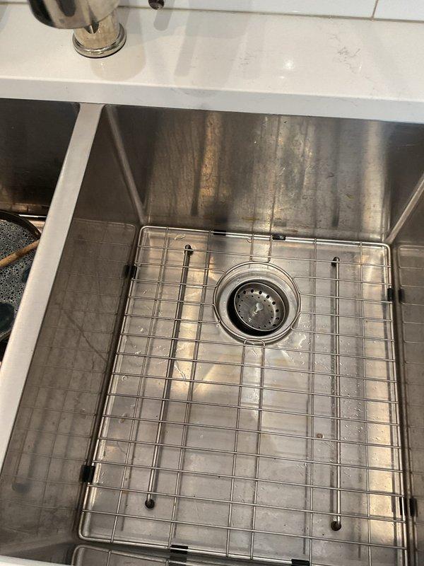 Responded to wastewater backup issue where kitchen sink drainage was flowing into shower drain in century-old residence. Performed main drain cleanout to clear blockage in shared waste line causing cross-contamination between fixtures. Successfully restored proper drainage flow, eliminating backup condition and ensuring independent operation of kitchen and bathroom plumbing systems.