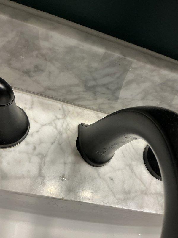 Returned to address ongoing leak issue following previous day's repair attempt. Inspected bathtub faucet assembly and drain components, including oil-rubbed bronze spout and fixtures mounted on marble deck. Identified persistent leak source, made necessary adjustments to faucet connections and verified proper sealing of all plumbing connections to resolve water leakage.